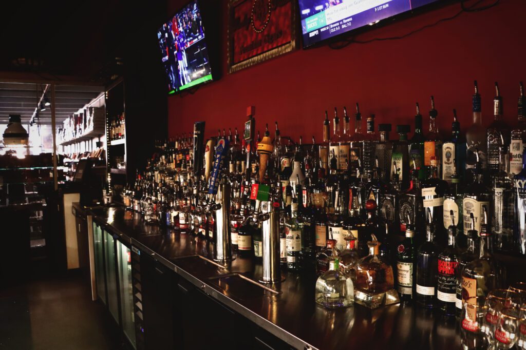 Classic Cigars bar with a long back bar of spirits under a red wall